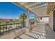 Covered balcony with decorative pillars offering views of desert landscape and neighboring houses at 841 Colina Alta Pl, Las Vegas, NV 89138