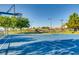 Outdoor basketball court with well-maintained surface and equipment, surrounded by green trees and landscaping at 841 Colina Alta Pl, Las Vegas, NV 89138
