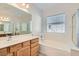 Bathroom features a double sink vanity, soaking tub, large mirror and a privacy window at 841 Colina Alta Pl, Las Vegas, NV 89138