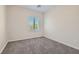 Neutral carpeted bedroom with window, light walls, and minimal decor for a serene feel at 841 Colina Alta Pl, Las Vegas, NV 89138