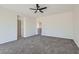 Carpeted bedroom with neutral walls offering two entryways with an overhead fan and light at 841 Colina Alta Pl, Las Vegas, NV 89138