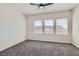 Neutral bedroom with soft carpeting and a ceiling fan, filled with natural light at 841 Colina Alta Pl, Las Vegas, NV 89138