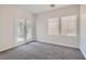 Cozy carpeted bedroom featuring natural lighting and a glass patio door at 841 Colina Alta Pl, Las Vegas, NV 89138