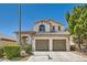 Inviting two-story home with a tile roof, lush landscaping, and a two-car garage at 841 Colina Alta Pl, Las Vegas, NV 89138