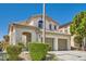 Charming two-story home featuring a tiled roof, arched entry, and manicured landscaping at 841 Colina Alta Pl, Las Vegas, NV 89138