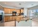 Bright kitchen featuring stainless steel appliances, a large island, and wood cabinetry at 841 Colina Alta Pl, Las Vegas, NV 89138