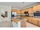 Well-lit kitchen with an island, stainless steel appliances, and wood cabinetry at 841 Colina Alta Pl, Las Vegas, NV 89138