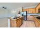 Open kitchen with a large island, stainless steel appliances, and wood floors at 841 Colina Alta Pl, Las Vegas, NV 89138