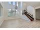 Spacious living room with high ceilings, chandelier, and wood staircase at 841 Colina Alta Pl, Las Vegas, NV 89138