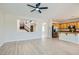 Spacious living room showcasing light wood flooring, staircase view and kitchen with stainless steel appliances at 841 Colina Alta Pl, Las Vegas, NV 89138