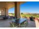 Enjoy stunning views from this outdoor seating area, perfect for relaxing and entertaining amidst beautiful landscaping and mountain vistas at 841 Colina Alta Pl, Las Vegas, NV 89138