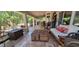 A covered back patio features comfortable seating, tile flooring, and an inviting outdoor space for relaxation and entertaining at 884 E Robindale Rd, Las Vegas, NV 89123