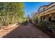 The backyard shows ample space with gravel landscaping with mature trees offering shade and privacy at 884 E Robindale Rd, Las Vegas, NV 89123