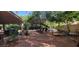 An expansive backyard features mature trees and comfortable lounge seating, creating a serene outdoor retreat at 884 E Robindale Rd, Las Vegas, NV 89123