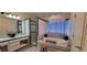 Bathroom with large soaking tub, shower, double vanity, and tiled walls at 884 E Robindale Rd, Las Vegas, NV 89123