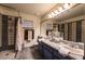 This bathroom features double sinks, a large mirror and a tiled walk-in shower at 884 E Robindale Rd, Las Vegas, NV 89123