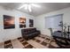 This bedroom includes a ceiling fan, a leather couch and a writing desk at 884 E Robindale Rd, Las Vegas, NV 89123