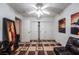 This bedroom features a ceiling fan, closet with sliding doors and contemporary art pieces at 884 E Robindale Rd, Las Vegas, NV 89123