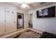 This bedroom has a ceiling fan, a large mirror and a wall mounted television at 884 E Robindale Rd, Las Vegas, NV 89123