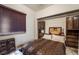 This bedroom has a window with wooden blinds and built in wood cabinets at 884 E Robindale Rd, Las Vegas, NV 89123