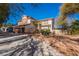 Charming two-story home featuring a large front yard, mature trees and a two car garage at 884 E Robindale Rd, Las Vegas, NV 89123
