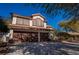 Charming two-story home featuring a large front yard, mature trees and a two car garage at 884 E Robindale Rd, Las Vegas, NV 89123