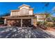 Inviting two-story home featuring a three-car garage and a well-maintained front yard at 884 E Robindale Rd, Las Vegas, NV 89123