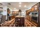 Spacious kitchen featuring wood cabinets, stainless steel appliances, and a large center island at 884 E Robindale Rd, Las Vegas, NV 89123