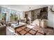 Bright living room featuring tile floors, large windows with shutters, and a staircase to the second floor at 884 E Robindale Rd, Las Vegas, NV 89123