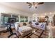 Comfortable living room with large windows, tile floors, and access to the kitchen at 884 E Robindale Rd, Las Vegas, NV 89123