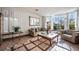 Sun-lit living room with large windows and classic decor featuring comfortable seating at 884 E Robindale Rd, Las Vegas, NV 89123