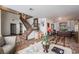 Spacious living room showcasing tile floors, an elegant staircase, and neutral wall paint at 884 E Robindale Rd, Las Vegas, NV 89123