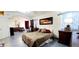 Spacious main bedroom suite with patterned bedspread, arched entryways, and tile flooring at 884 E Robindale Rd, Las Vegas, NV 89123