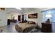 Spacious main bedroom suite with patterned bedspread, arched entryways, and tile flooring at 884 E Robindale Rd, Las Vegas, NV 89123