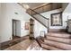 Detailed view of the staircase featuring tile steps, wood railings, and decorative wall art at 884 E Robindale Rd, Las Vegas, NV 89123