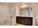 Modern bathroom boasts dual sinks, dark wood cabinets, quartz counters and glass enclosed shower at 8909 Cherry Barn St, Las Vegas, NV 89113
