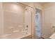 Bright bathroom featuring shower-over-tub, neutral walls and tile and view to bedroom at 8909 Cherry Barn St, Las Vegas, NV 89113