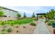 Community common area with lush green grass, walking paths, benches and mature trees at 8909 Cherry Barn St, Las Vegas, NV 89113