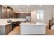 Modern kitchen with stainless steel appliances, central island, and warm cabinetry at 8909 Cherry Barn St, Las Vegas, NV 89113