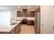 Modern kitchen features stainless steel appliances, dark wood cabinets, and a bright white countertop island at 8909 Cherry Barn St, Las Vegas, NV 89113
