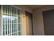 Apartment 209 entryway features door and window with blinds in neutral color scheme at 9070 Spring Mountain Rd # 209, Las Vegas, NV 89117