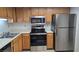 Kitchen features stainless steel appliances, wood cabinets, and ample counter space at 9070 Spring Mountain Rd # 209, Las Vegas, NV 89117