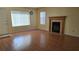 Inviting living room featuring wood floors, a fireplace, and natural light at 9070 Spring Mountain Rd # 209, Las Vegas, NV 89117