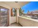 View from private balcony features beautiful door, stucco walls, and lush community landscaping at 9303 Gilcrease Ave # 1243, Las Vegas, NV 89149