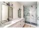 This bathroom has a dual vanity, a marble countertop, and a glass-walled shower at 9303 Gilcrease Ave # 1243, Las Vegas, NV 89149