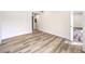 Bedroom with gray wood floors, bright white walls, and a view into the next room at 9303 Gilcrease Ave # 1243, Las Vegas, NV 89149