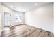 This bedroom has bright light, wood floors, a window, and a door with privacy glass at 9303 Gilcrease Ave # 1243, Las Vegas, NV 89149