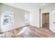 Bright bedroom with wood floors, two windows, and a door to the ensuite bathroom at 9303 Gilcrease Ave # 1243, Las Vegas, NV 89149