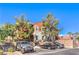 Two-story residential building with mature shade trees, parking, and exterior stucco at 9303 Gilcrease Ave # 1243, Las Vegas, NV 89149