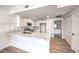 Open kitchen with white cabinets, quartz counters, stainless appliances and light wood-look flooring at 9303 Gilcrease Ave # 1243, Las Vegas, NV 89149